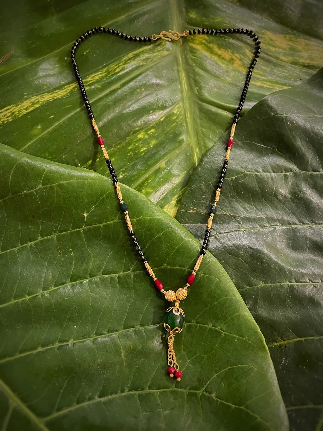 Short Mangalsutra Designs Gold Plated Oval Shape Pendant with Latkan Red Green Beads (20 Inches)