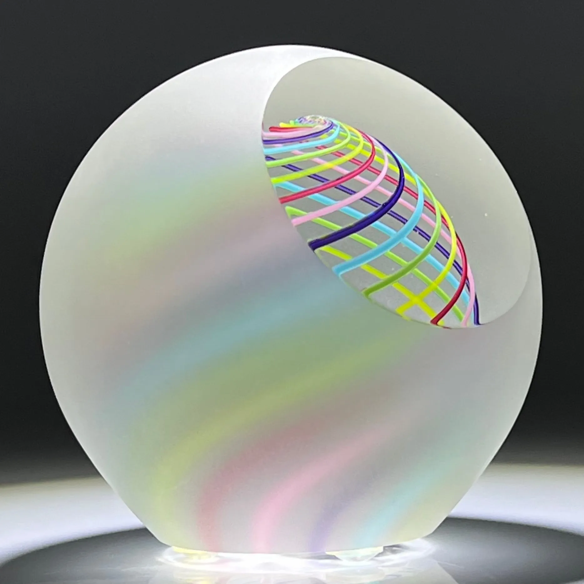 Signed Paul Harrie Contemporary Glass Art Paperweight With Spiral Rainbow Design and Faceted Frosted Surface