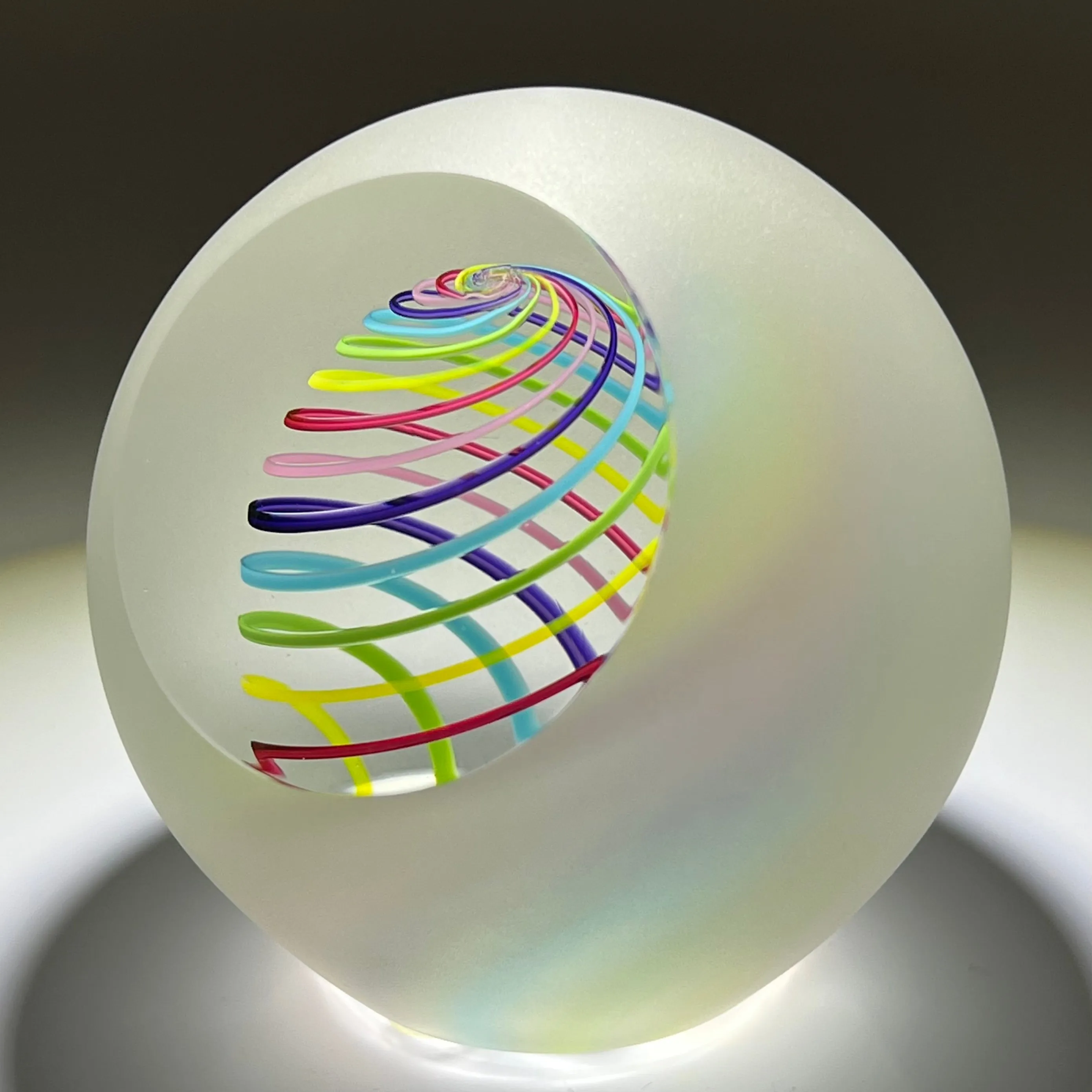 Signed Paul Harrie Contemporary Glass Art Paperweight With Spiral Rainbow Design and Faceted Frosted Surface